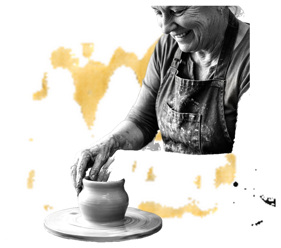 A potter shaping a bowl on the wheel over yellow paint