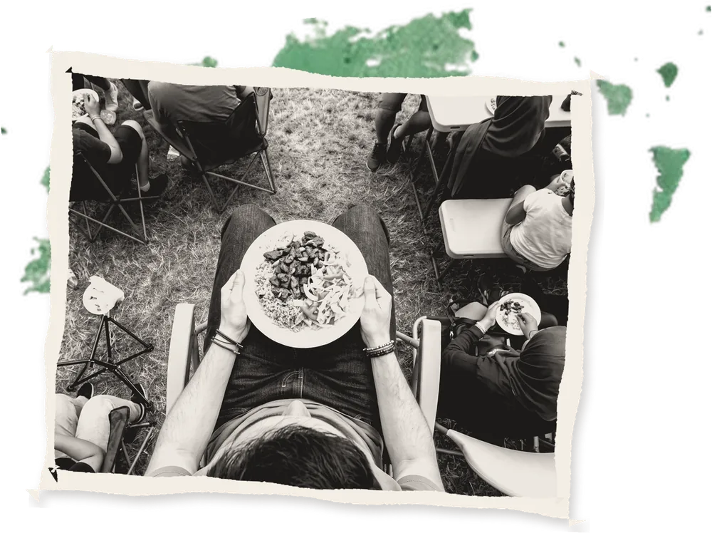 A plate of food held on a lap at a festival